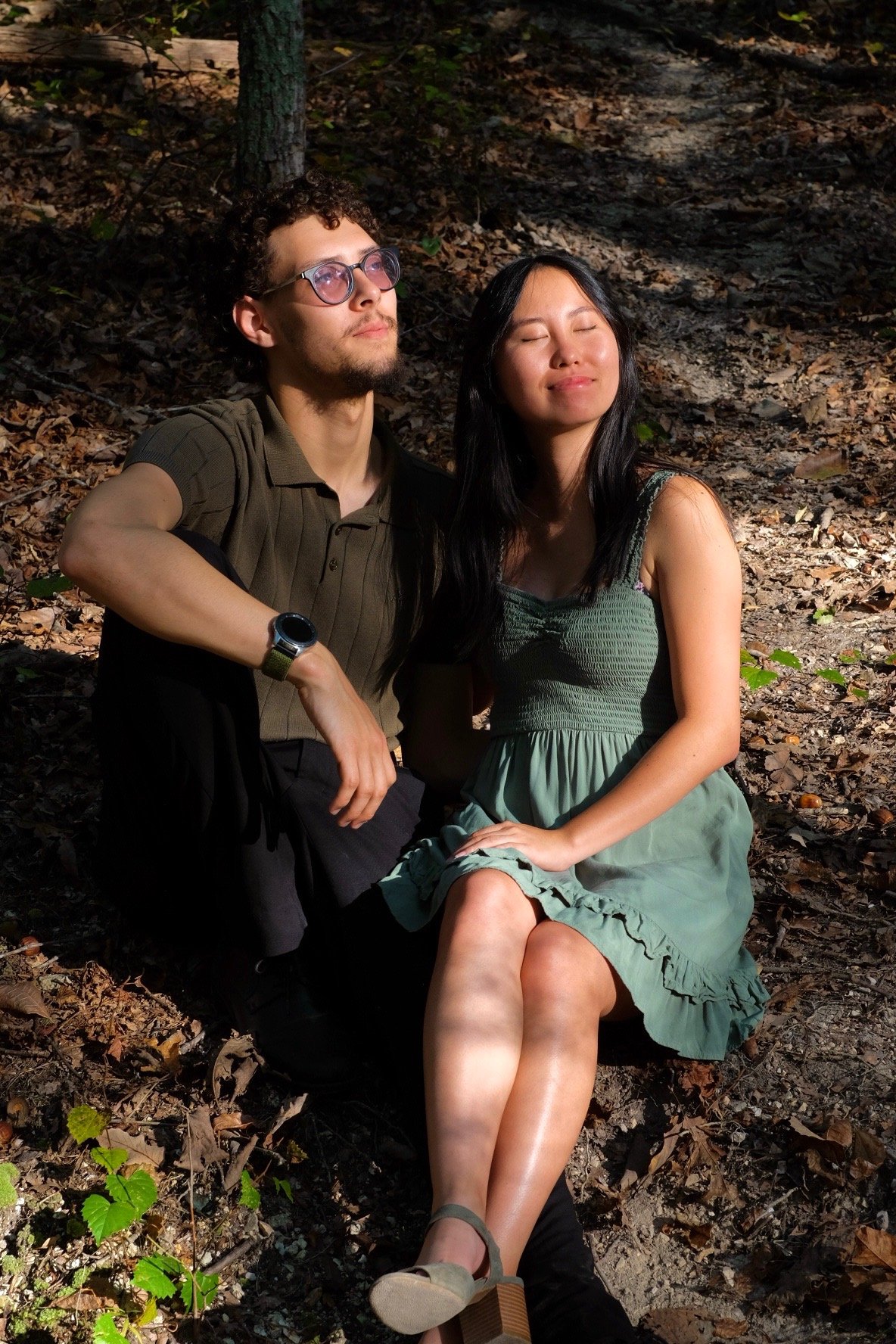 Eri and Eliana sitting together in the forest